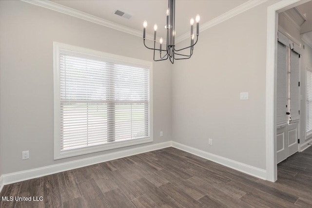 unfurnished dining area featuring an inviting chandelier, ornamental molding, dark wood finished floors, and a healthy amount of sunlight