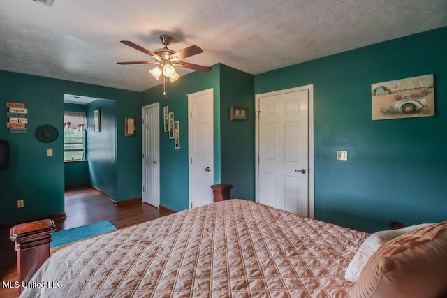 bedroom featuring baseboards, ceiling fan, and wood finished floors