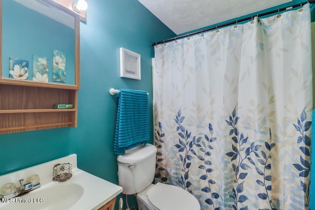 bathroom featuring toilet, curtained shower, and vanity