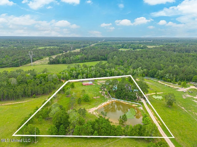 drone / aerial view featuring a wooded view