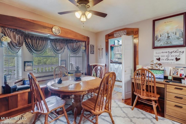 dining space featuring a ceiling fan and wood finished floors