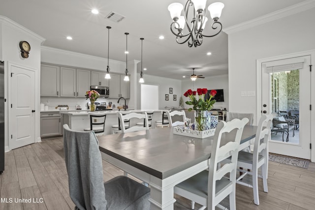 9363 Taylor Pl, Ocean Springs, MS 39564 - dining space featuring crown molding, light wood finished floors, recessed lighting, a chandelier, and ceiling fan