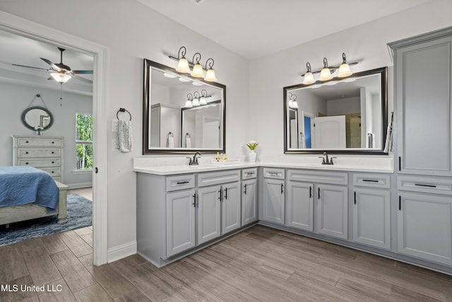 9363 Taylor Pl, Ocean Springs, MS 39564 - bathroom featuring wood finished floors, ceiling fan, baseboards, and double vanity