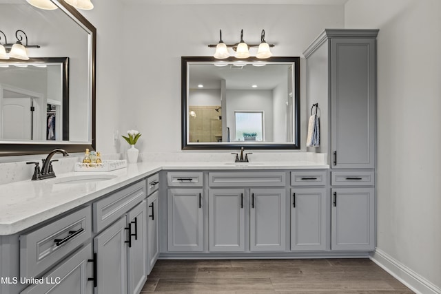 9363 Taylor Pl, Ocean Springs, MS 39564 - bathroom featuring double vanity, a tile shower, and wood finished floors