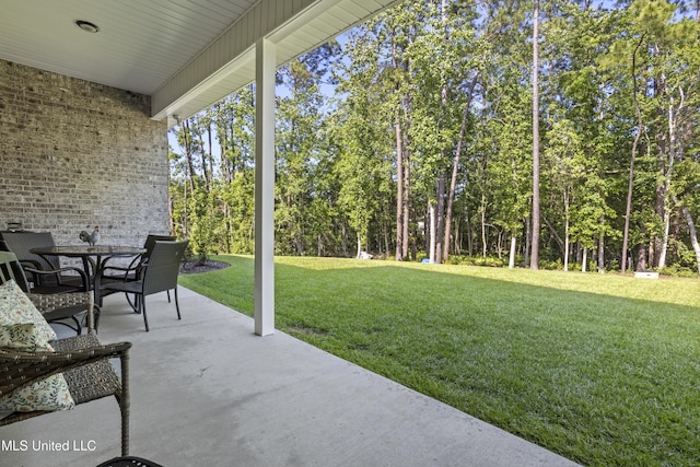 9363 Taylor Pl, Ocean Springs, MS 39564 - view of patio / terrace featuring outdoor dining area and view of scattered trees