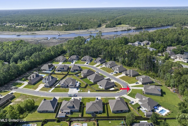 9363 Taylor Pl, Ocean Springs, MS 39564 - aerial overview of property's location with a heavily wooded area, a large body of water, and nearby suburban area