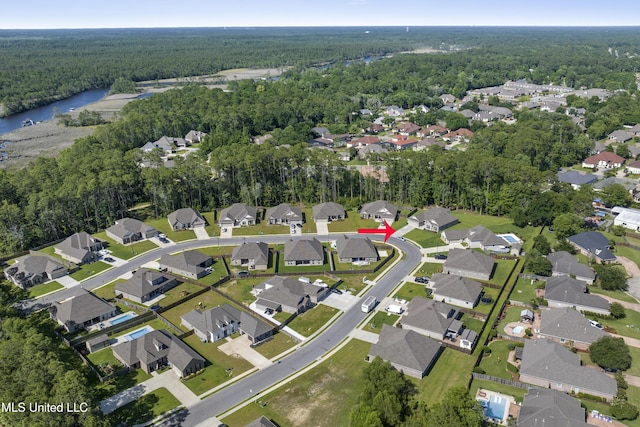 9363 Taylor Pl, Ocean Springs, MS 39564 - aerial overview of property's location with a heavily wooded area, nearby suburban area, and a large body of water