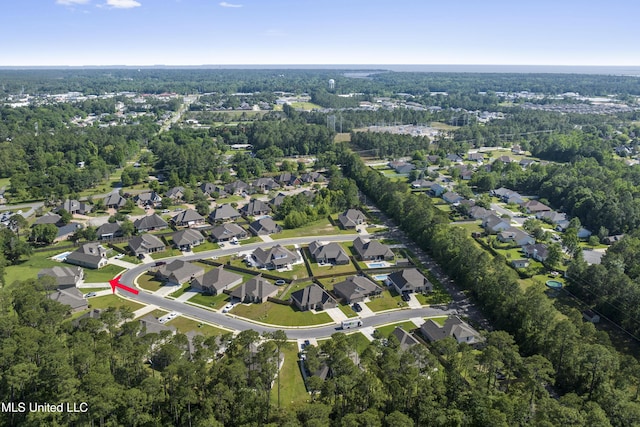 9363 Taylor Pl, Ocean Springs, MS 39564 - aerial overview of property's location with nearby suburban area and a heavily wooded area