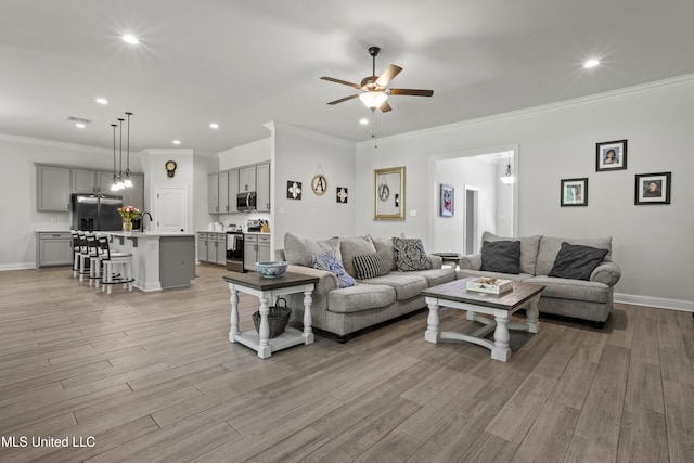 9363 Taylor Pl, Ocean Springs, MS 39564 - living room featuring ceiling fan, light wood finished floors, recessed lighting, baseboards, and crown molding