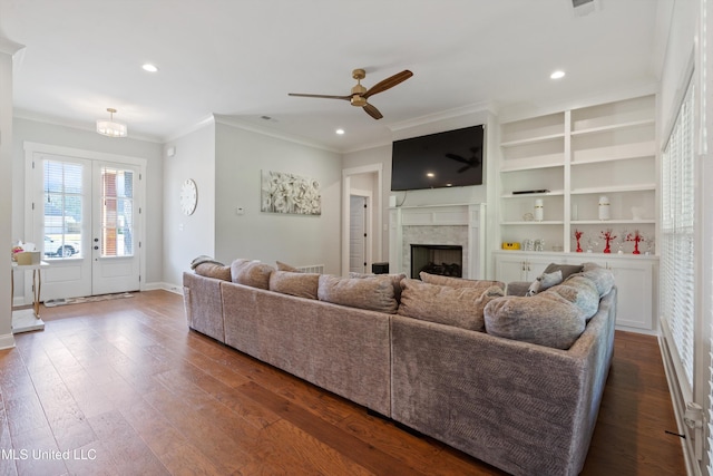 6731 Bobwhite Cir, Southaven, MS 38672 - living room with ornamental molding, ceiling fan, a fireplace, baseboards, and dark wood-style flooring