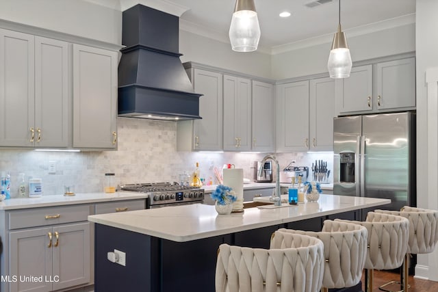 6731 Bobwhite Cir, Southaven, MS 38672 - kitchen with premium range hood, stainless steel appliances, a kitchen bar, ornamental molding, and pendant lighting