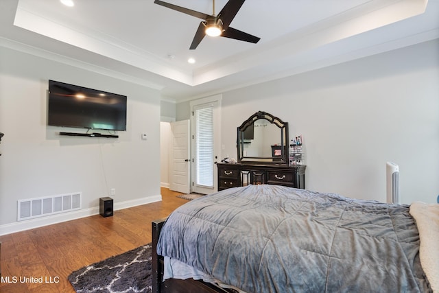 6731 Bobwhite Cir, Southaven, MS 38672 - bedroom featuring a raised ceiling, wood finished floors, recessed lighting, crown molding, and baseboards