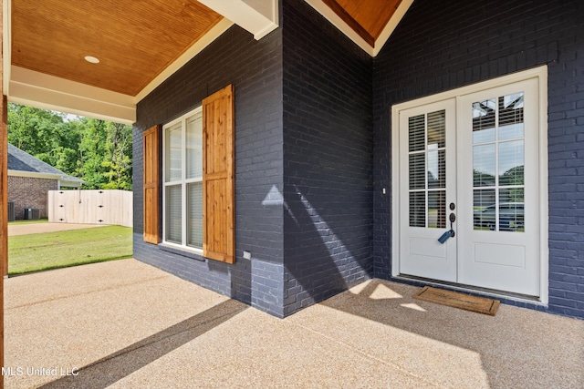 6731 Bobwhite Cir, Southaven, MS 38672 - view of exterior entry featuring french doors, brick siding, and central air condition unit
