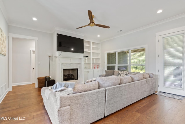 6731 Bobwhite Cir, Southaven, MS 38672 - living area with a ceiling fan, ornamental molding, wood finished floors, a high end fireplace, and recessed lighting