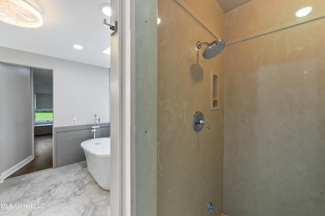 bathroom featuring separate shower and tub