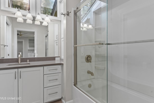 bathroom with vanity, a healthy amount of sunlight, a skylight, and shower / bath combination with glass door