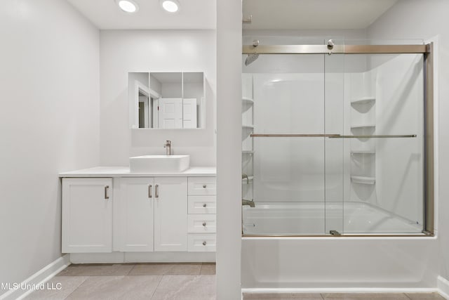 bathroom featuring vanity, enclosed tub / shower combo, and tile patterned floors