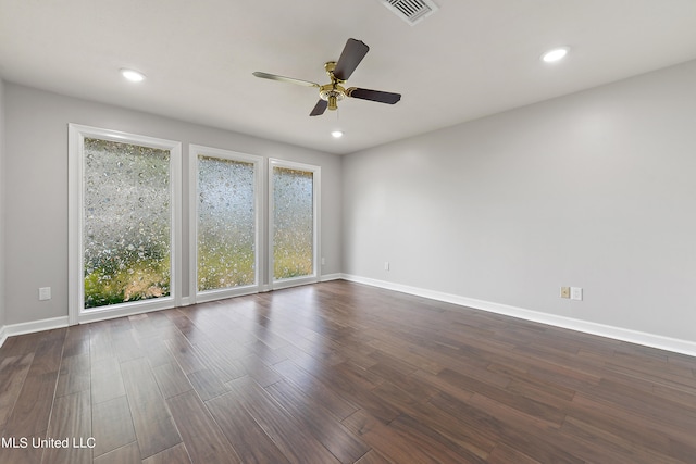 empty room featuring ceiling fan and dark hardwood / wood-style flooring