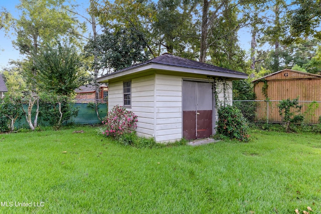 view of outbuilding featuring a lawn