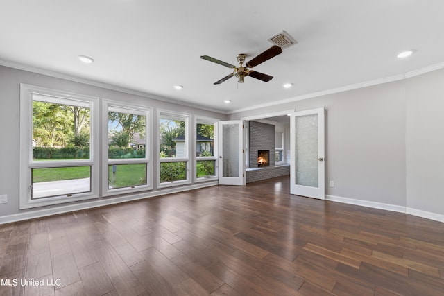 unfurnished living room with crown molding, dark hardwood / wood-style floors, a fireplace, and ceiling fan