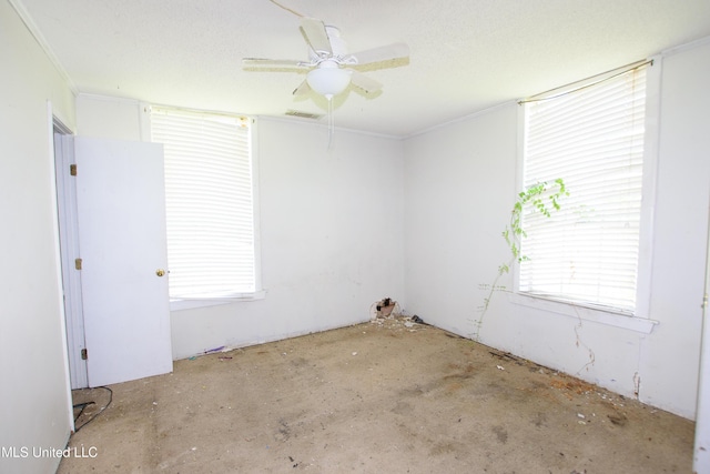 unfurnished room featuring healthy amount of natural light, ceiling fan, and ornamental molding