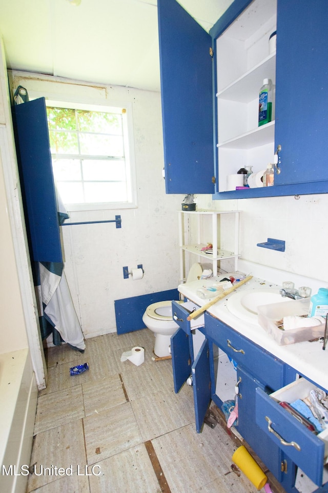 full bath featuring toilet, wood finished floors, and vanity