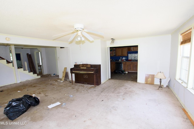 living room featuring stairs and ceiling fan