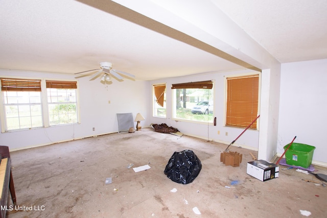 unfurnished living room featuring healthy amount of natural light and a ceiling fan