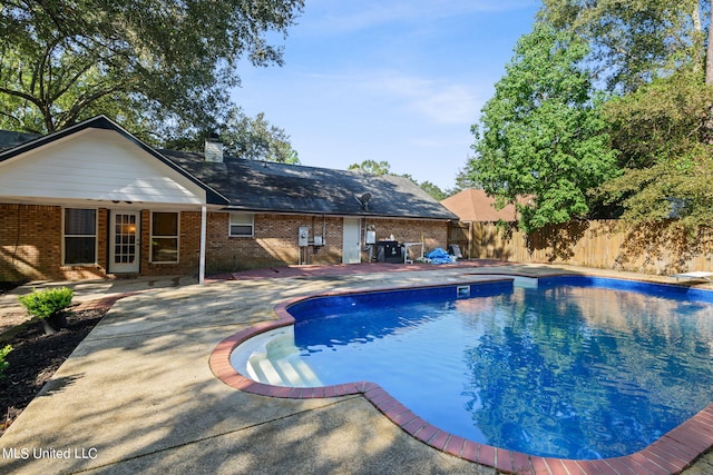 view of pool featuring french doors and a patio area