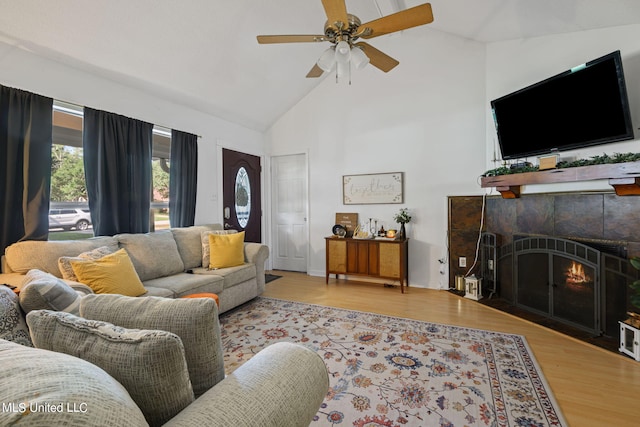 living room featuring ceiling fan, high vaulted ceiling, and light hardwood / wood-style flooring