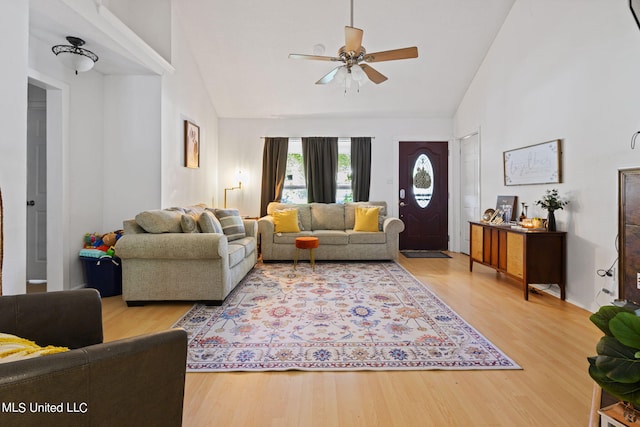 living room featuring hardwood / wood-style flooring, high vaulted ceiling, and ceiling fan