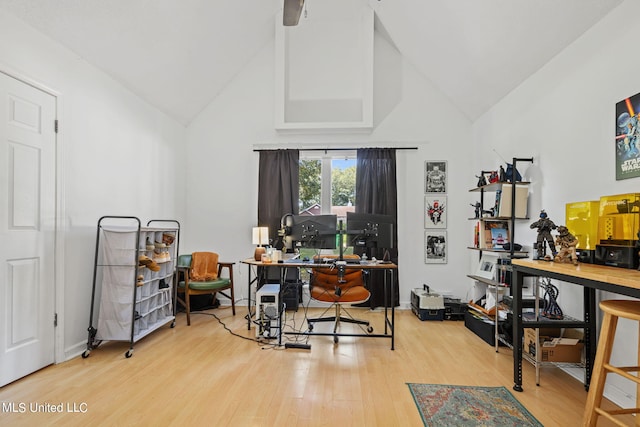 home office with hardwood / wood-style floors and high vaulted ceiling