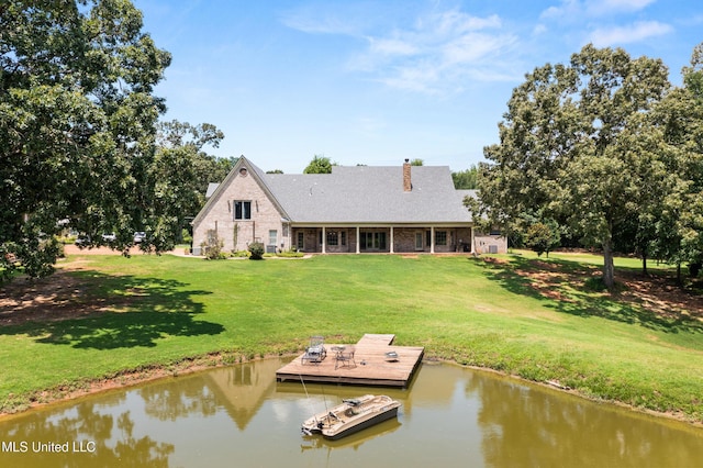 445 Carey Chapel Rd, Red Banks, MS 38661 - rear view of house featuring a chimney, a lawn, and a water view