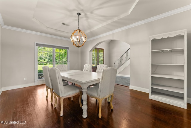 445 Carey Chapel Rd, Red Banks, MS 38661 - dining area with arched walkways, a chandelier, hardwood / wood-style floors, stairs, and a raised ceiling