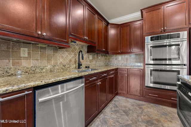 445 Carey Chapel Rd, Red Banks, MS 38661 - kitchen featuring appliances with stainless steel finishes, crown molding, light stone counters, tasteful backsplash, and reddish brown cabinets