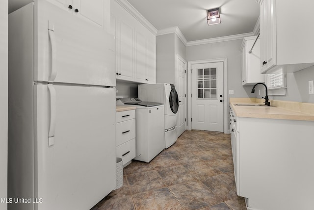 445 Carey Chapel Rd, Red Banks, MS 38661 - washroom featuring ornamental molding, washer and dryer, and stone finish flooring