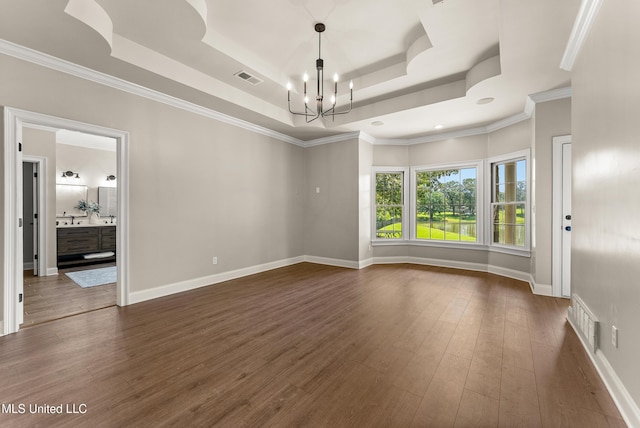 445 Carey Chapel Rd, Red Banks, MS 38661 - unfurnished room with a chandelier, a tray ceiling, and dark wood-style floors