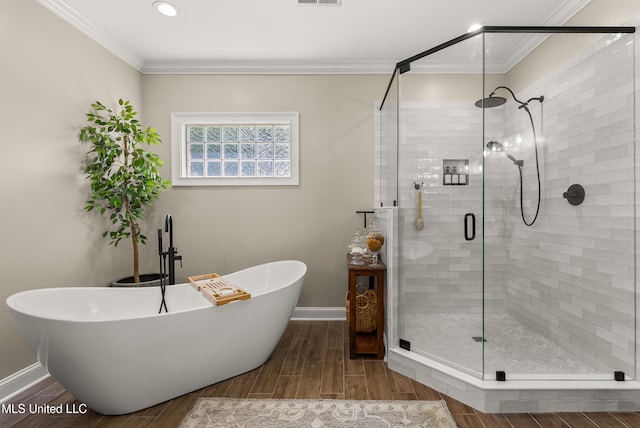 445 Carey Chapel Rd, Red Banks, MS 38661 - full bath featuring a freestanding tub, wood finished floors, a stall shower, ornamental molding, and recessed lighting