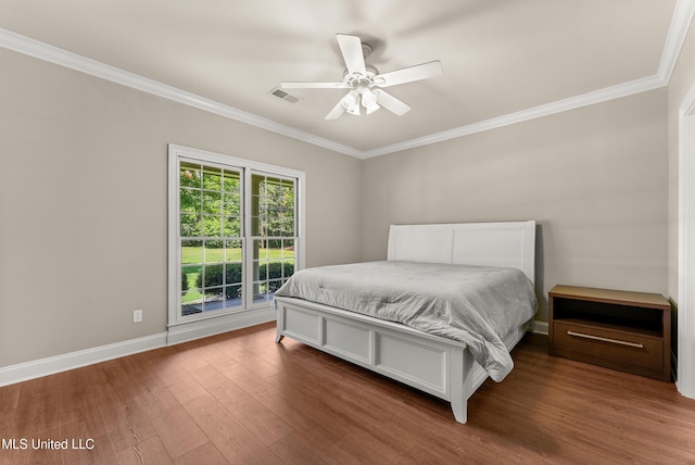 445 Carey Chapel Rd, Red Banks, MS 38661 - bedroom featuring crown molding, wood finished floors, and ceiling fan