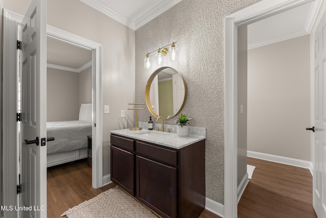 445 Carey Chapel Rd, Red Banks, MS 38661 - ensuite bathroom with wood finished floors, vanity, crown molding, and a textured wall