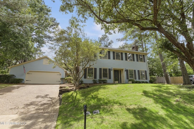 121 Kenbridge Ln, Madison, MS 39110 - colonial home with driveway, a chimney, a garage, fence, and a front lawn