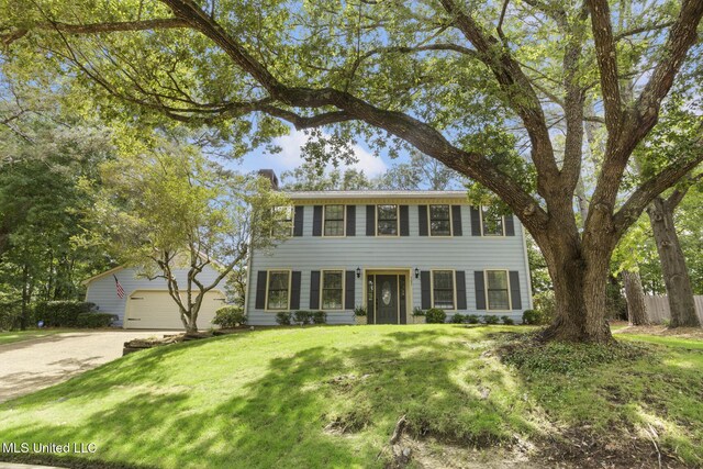 121 Kenbridge Ln, Madison, MS 39110 - colonial-style house featuring a chimney, dirt driveway, and a front yard
