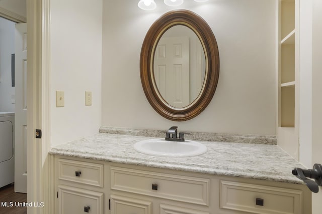 121 Kenbridge Ln, Madison, MS 39110 - bathroom with washer / dryer, vanity, and wood finished floors