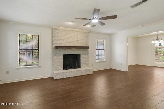 121 Kenbridge Ln, Madison, MS 39110 - unfurnished living room with ornamental molding, ceiling fan with notable chandelier, dark wood finished floors, and visible vents