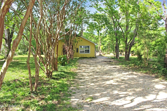exterior space with dirt driveway