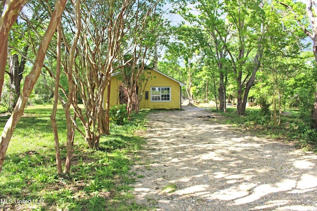 exterior space featuring dirt driveway