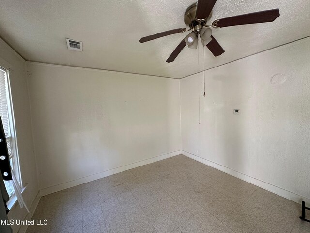 315 S Bolivar Ave, Cleveland, MS 38732 - unfurnished room featuring tile patterned floors, ceiling fan, a textured ceiling, and baseboards
