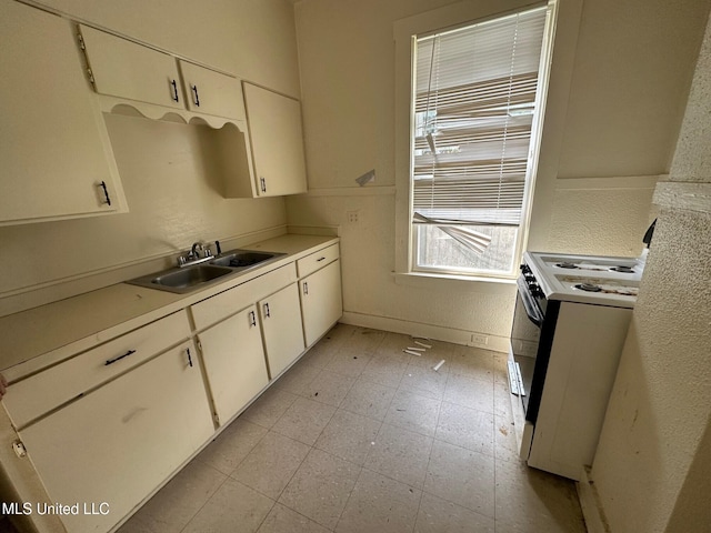 315 S Bolivar Ave, Cleveland, MS 38732 - kitchen featuring a sink, white electric range oven, light countertops, white cabinets, and light flooring