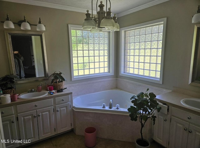 bathroom with vanity, a relaxing tiled tub, and a healthy amount of sunlight