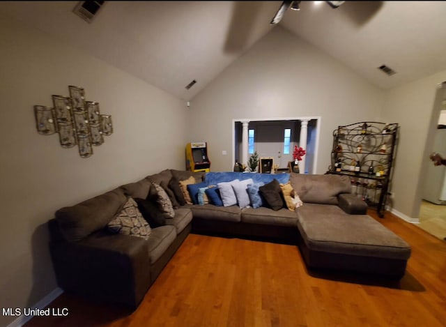 living room featuring hardwood / wood-style floors and high vaulted ceiling